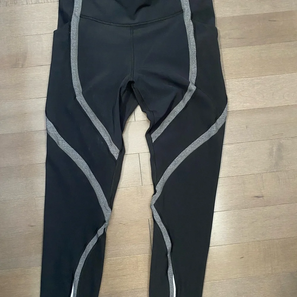 Lululemon leggings with side and back pockets. Size 10 black with gray design. - Picture 2 of 9